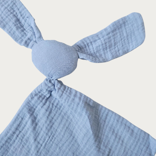 Sky blue muslin bunny security blanket with long ears, round head and squared body. Little Scandi baby Close Up