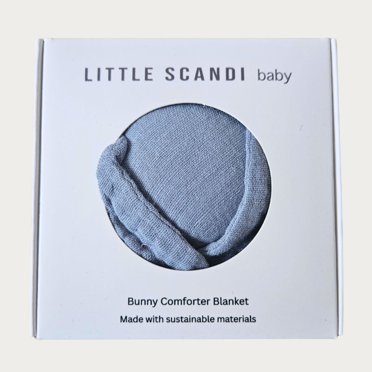 Packaging of a Bunny Comforter Blanket by Little Scandi baby on a light beige background