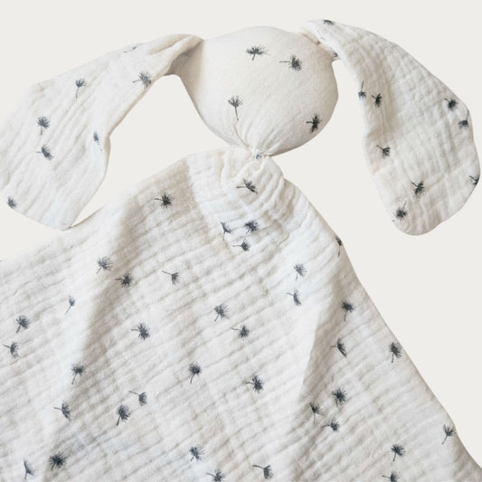 Cream bunny comforter blanket with black dandelion pattern design with a round head and squared body and two long ears