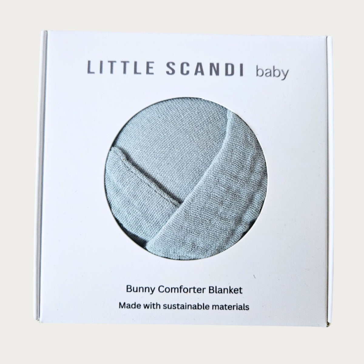 Packaging of a Bunny Comforter Blanket by Little Scandi baby on a light beige background